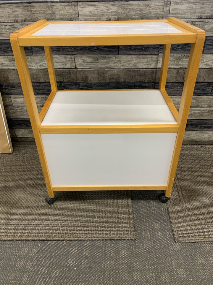 ROLLING KITCHEN CART BLONDE WOOD & WHITE W/TILE COUNTER TOP & 2 DOORS.