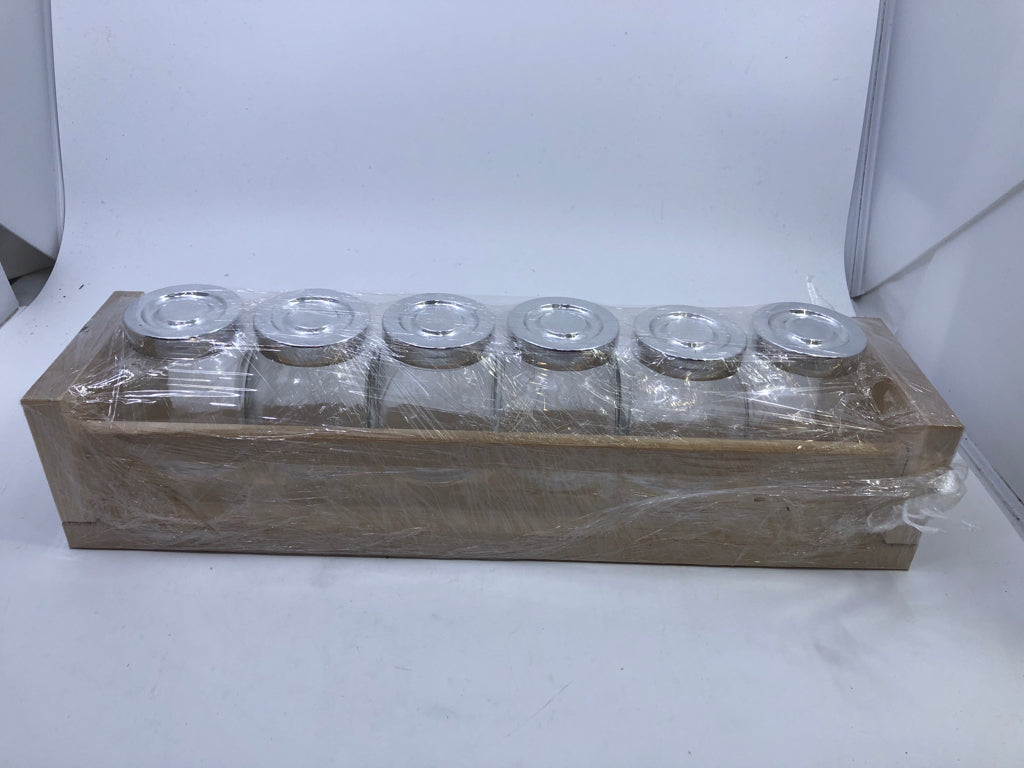 GLASS JARS IN WHITE SHELF.