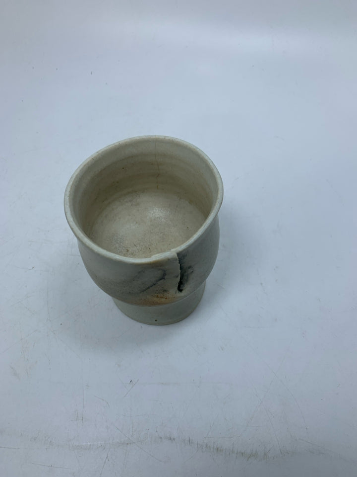 CREAM POTTERY IMPERFECT FOOTED CUP.