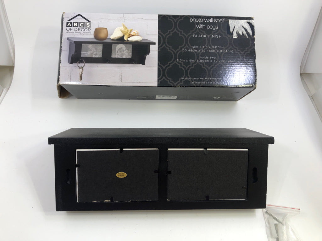 NIB BLACK PHOTO WALL SHELF WITH PEGS.