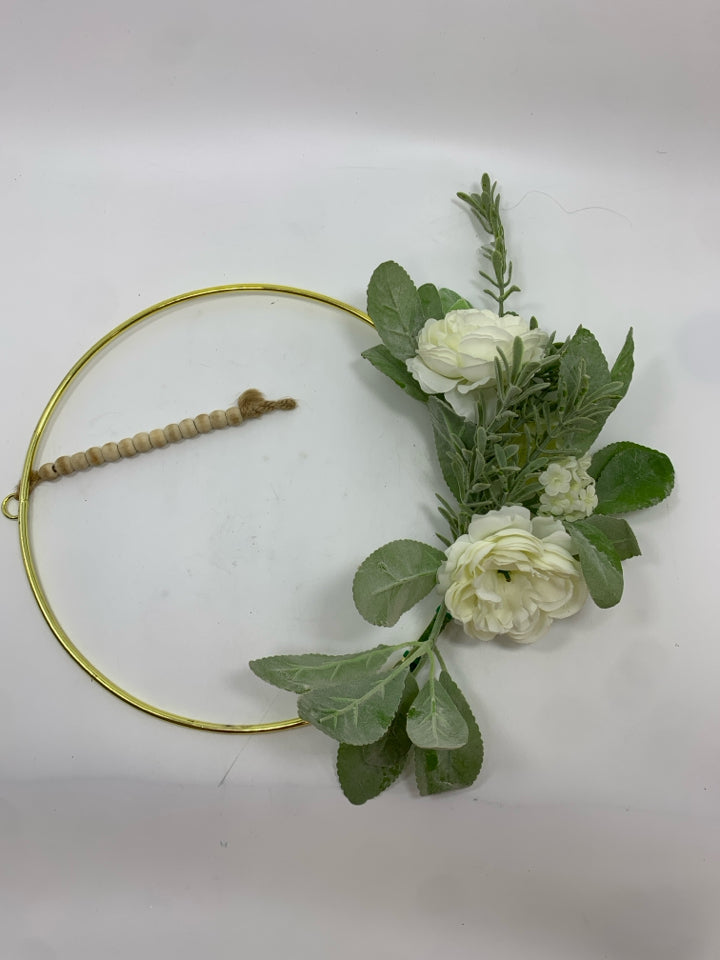 FAUX WHITE FLOWERS ON GOLD RING WREATH.