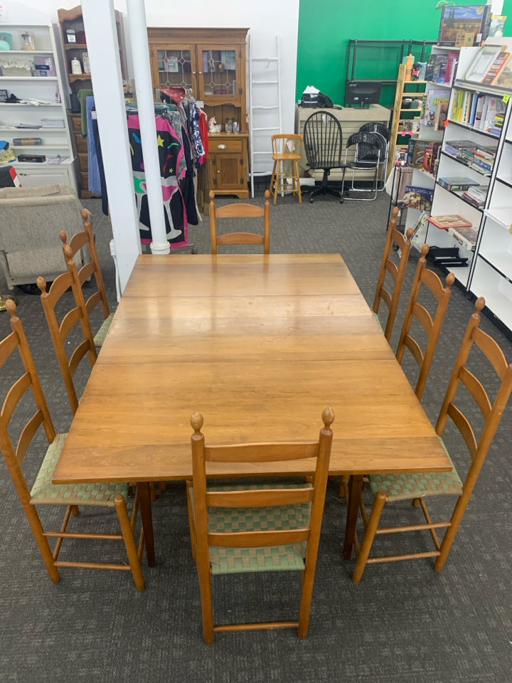 WOOD DINING TABLE W/8 LADDER BACK WOVEN SEAT CHAIRS AND LEAF.