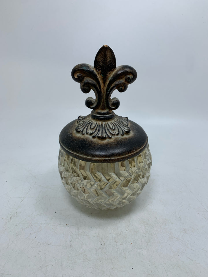 TEXTURED GLASS VASE W/ RESIN SCROLL LID.