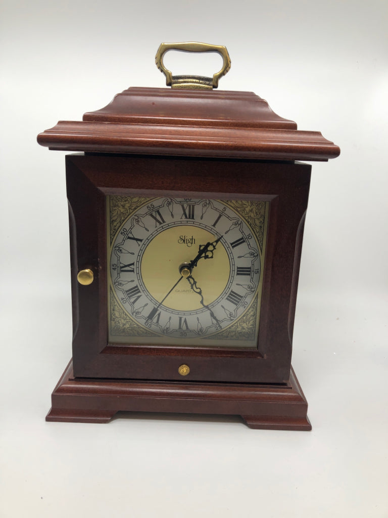 SLIGH CLOCK W/ 3 DRAWERS INSIDE.
