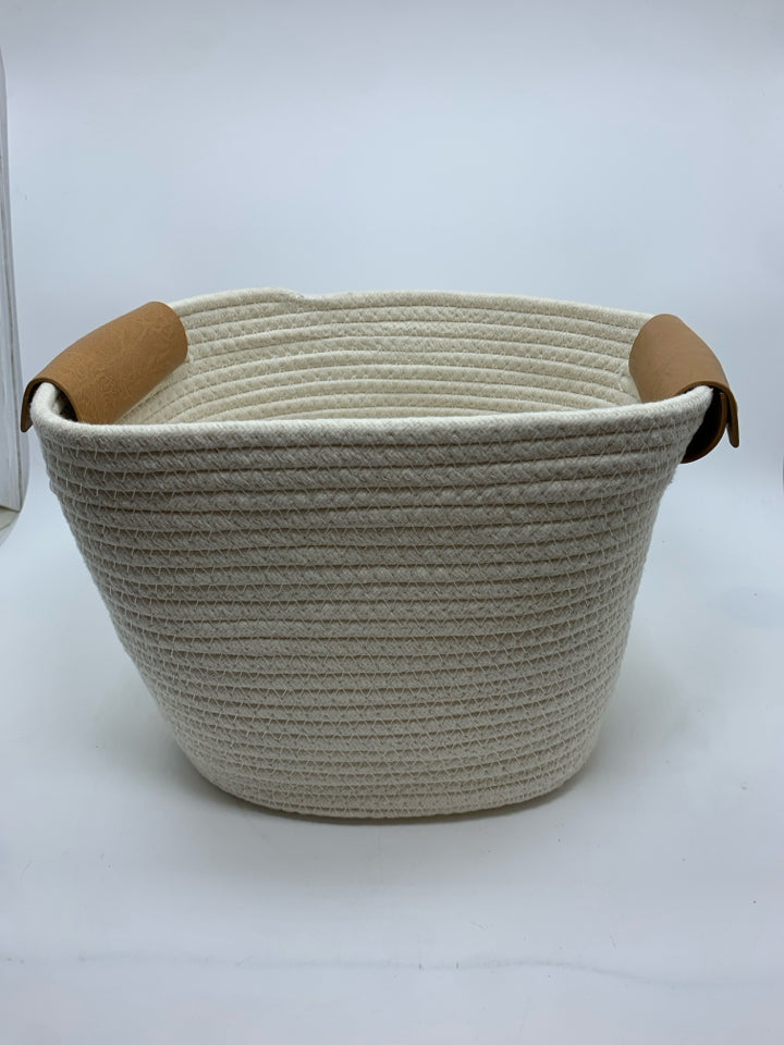 WHITE CLOTH BASKET W/LEATHER HANDLES.