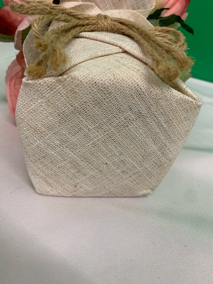 FAUX PINK FLORAL IN BURLAP PLANTER.
