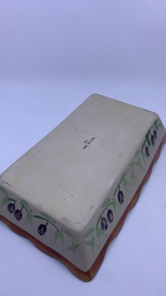 OLIVE CASSEROLE DISH IN METAL HOLDER.