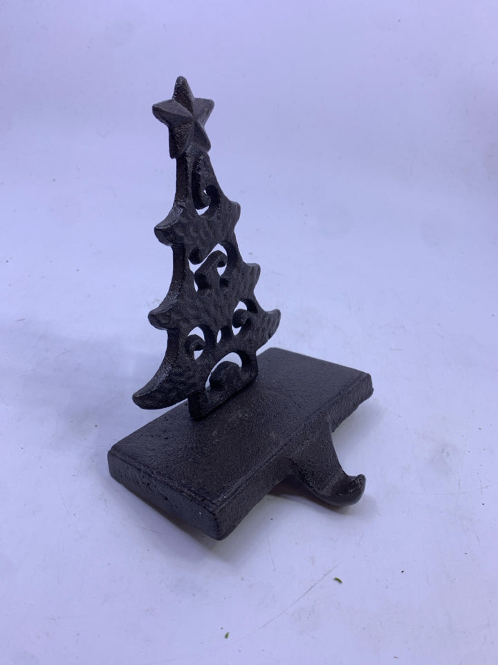 BROWN METAL CUTOUT TREE STOCKING HOLDER.