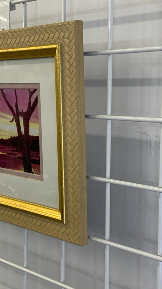 SUNSET PHOTO IN GOLD FRAME.