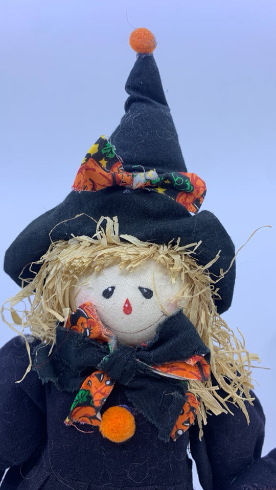 SCARECROW DRESSED UP AS A WITCH BLACK.