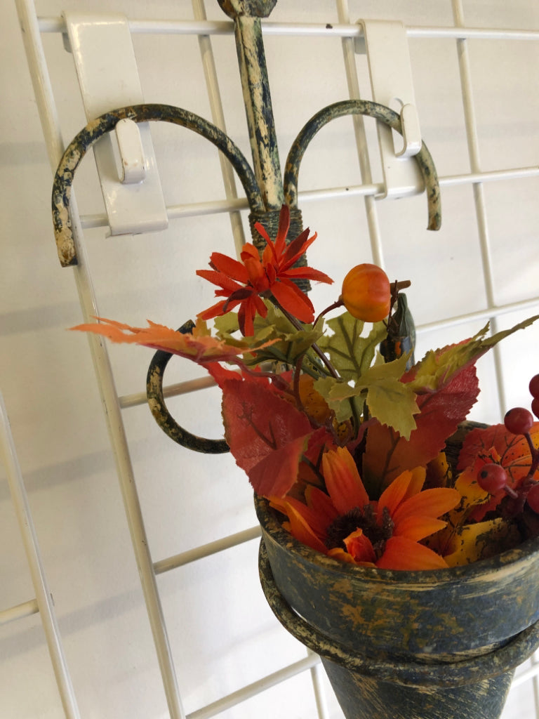 FAUX AUTUMN PLANTER IN RUSTIC METAL WALL HANGING.