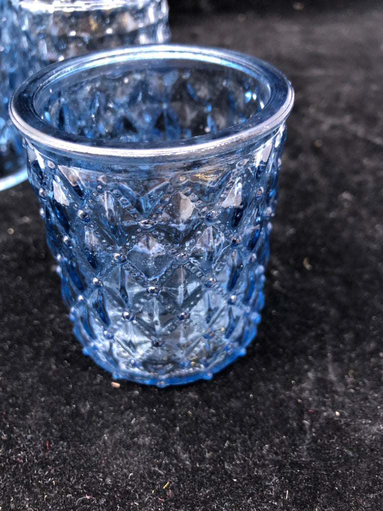 4 BLUE GLASS TEA LIGHT CANDLE HOLDERS.