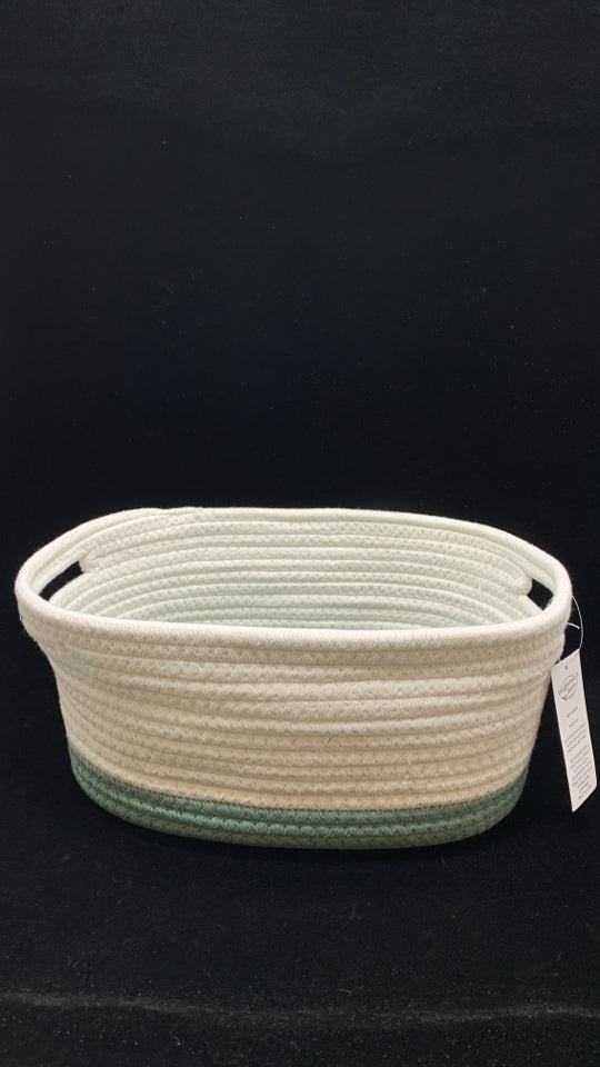 GREEN/WHITE WOVEN OVAL STORAGE BIN.