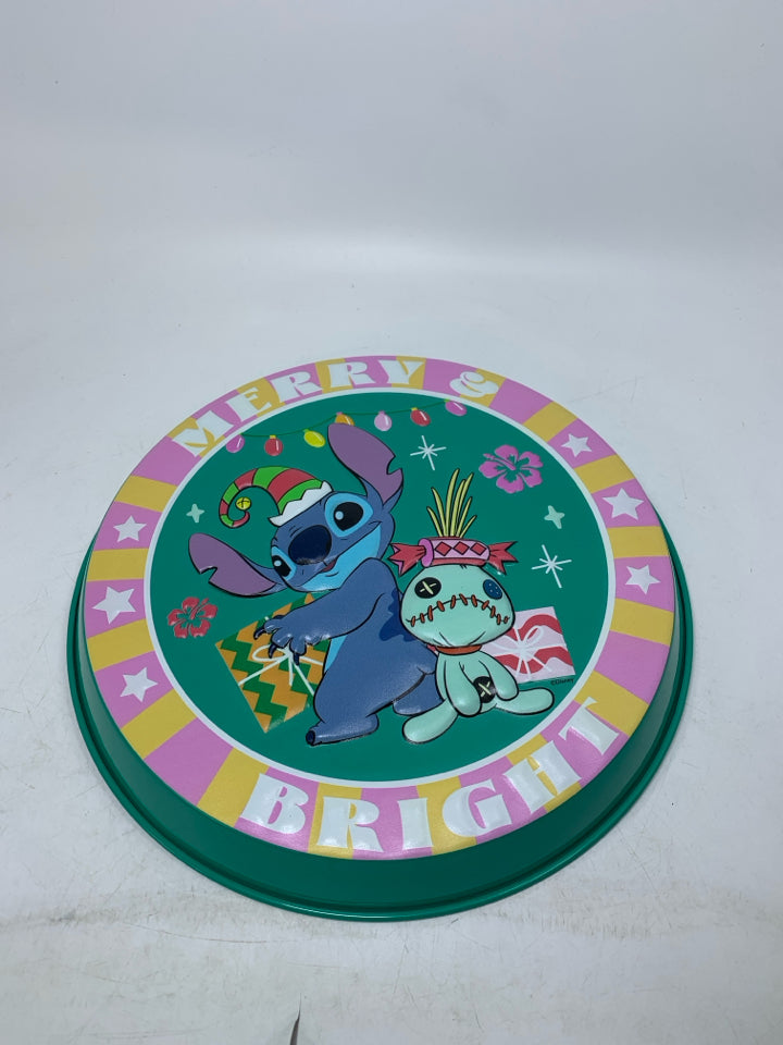 STITCH MERRY AND BRIGHT EMBOSSED METAL WALL HANGING.