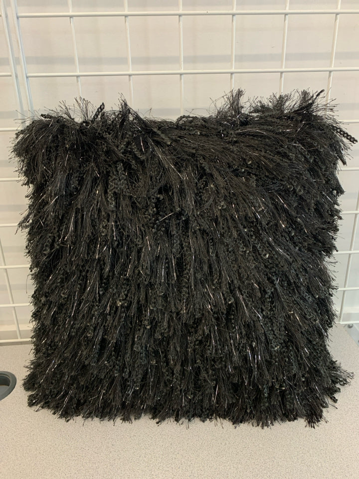 BLACK FURRY PILLOW W/TINSEL ACCENTS.