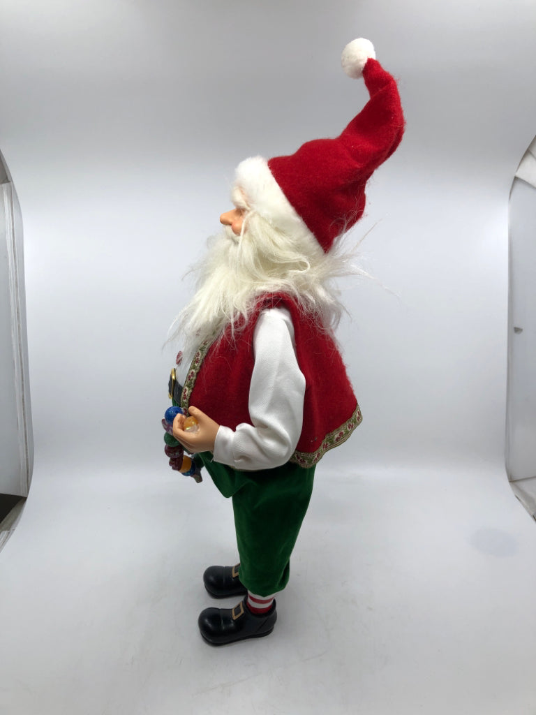 STANDING SANTA HOLDING GARLAND W/ RED VEST.