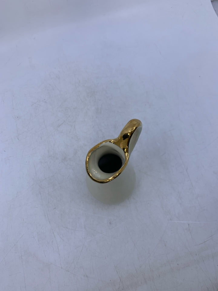 SMALL IVORY IRIDESCENT PITCHER W/ GOLD DETAILS.