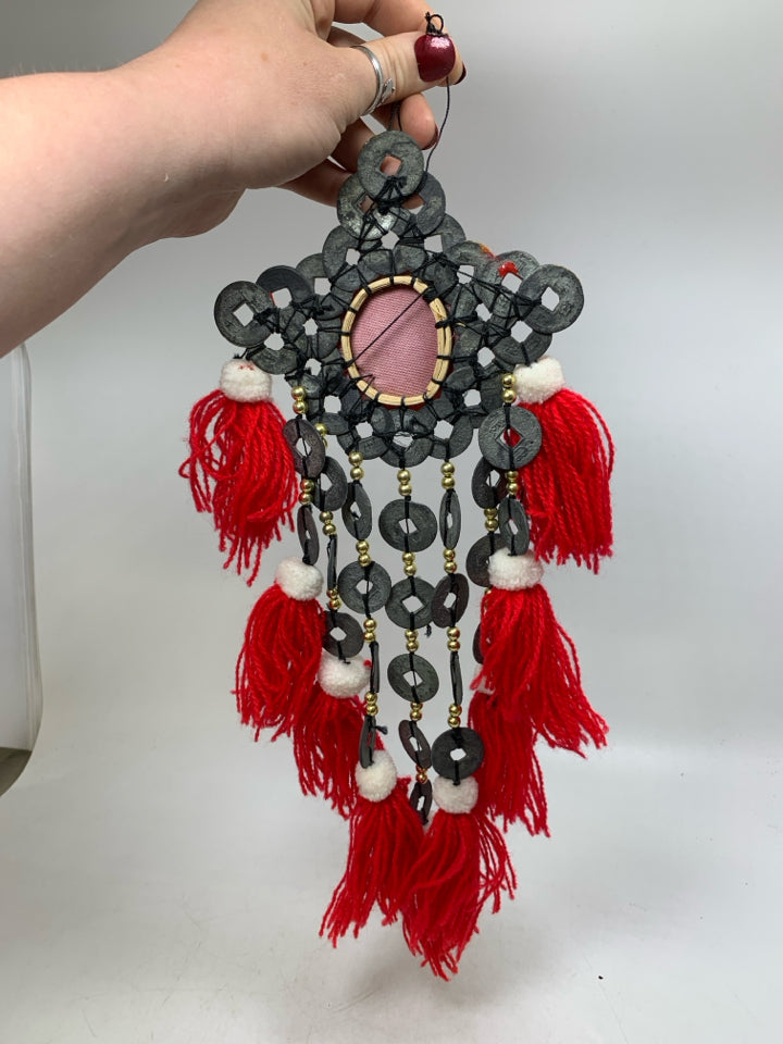 HANGING ABSTRACT METAL MEDALLIONS W/ RED TASSELS.