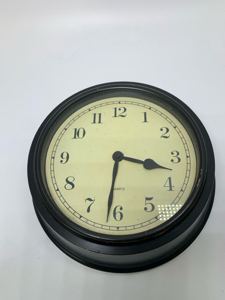 THICK BLACK PLASTIC WALL CLOCK.