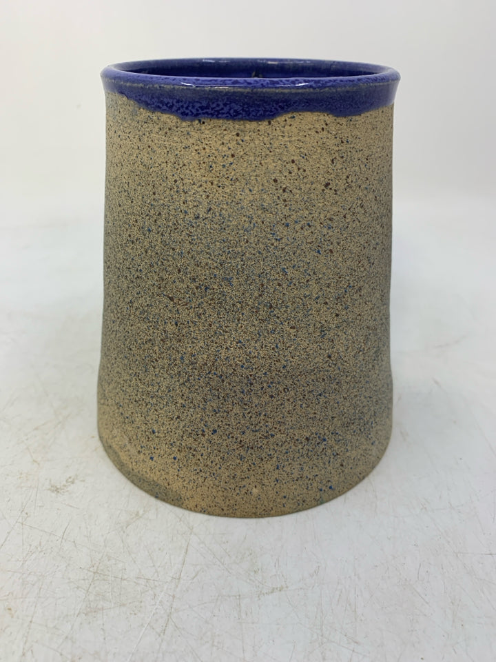 TEXTURED TAN POTTERY TEA LIGHT W/ MOTHER MARY/JOSEPH CUT OUT BLUE INSIDE.