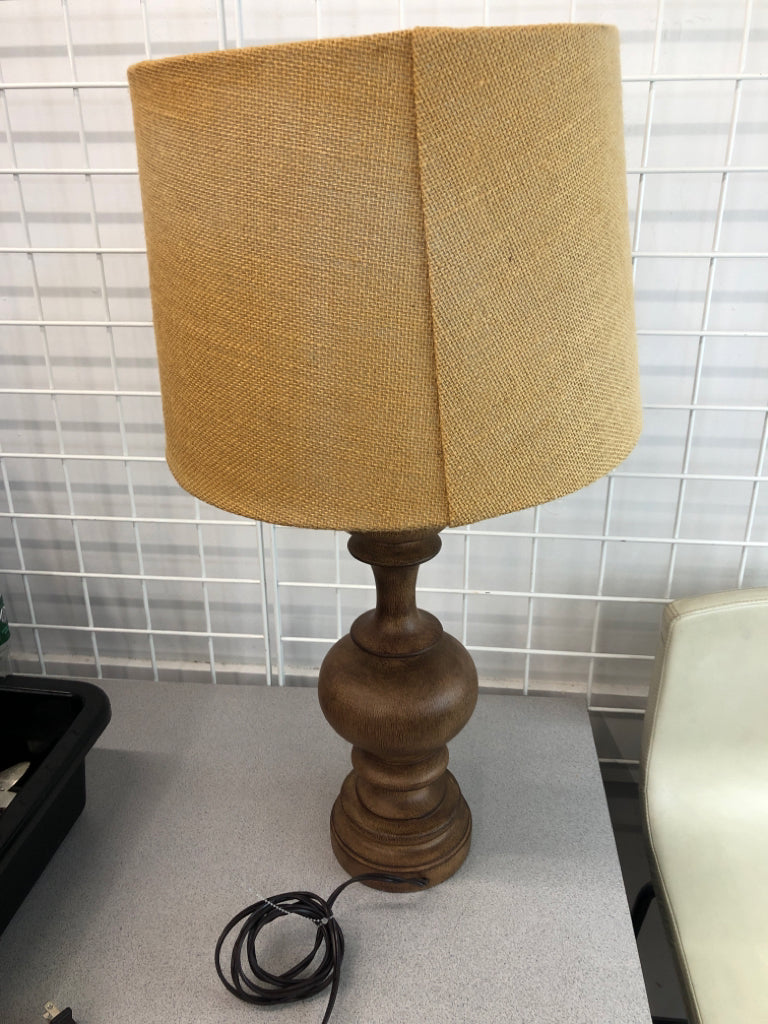 WOOD CARVED LAMP W/BURLAP SHADE.