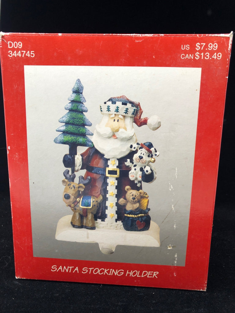 NIB WOOD CARVED SANTA W/PUPPIES STOCKING HOLDER.