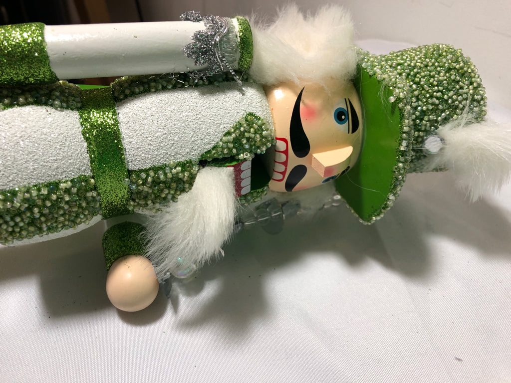 GREEN AND WHITE GLITTER NUT CRACKER.