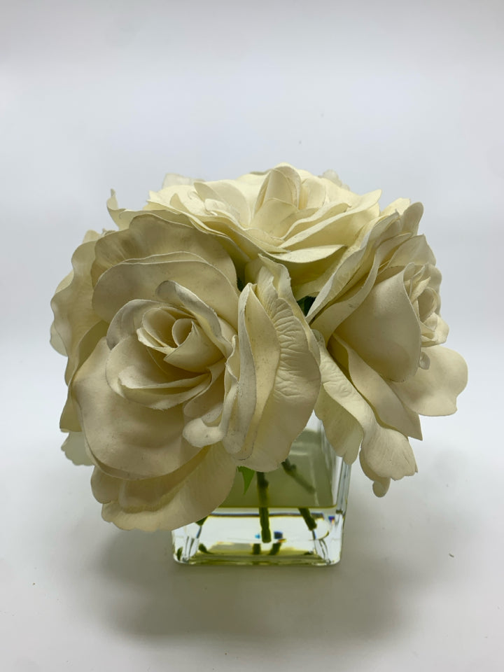 WHITE FAUX ROSES IN SQUARE GLASS VASE.