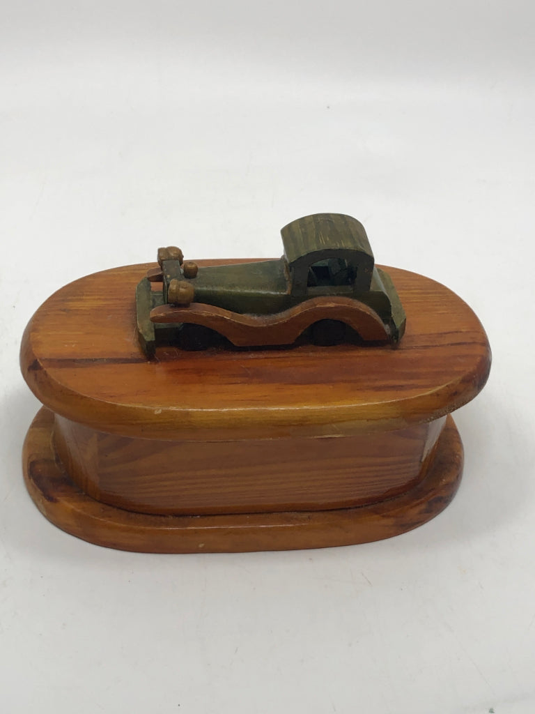 POLISHED WOODEN BOX WITH CAR ON TOP.