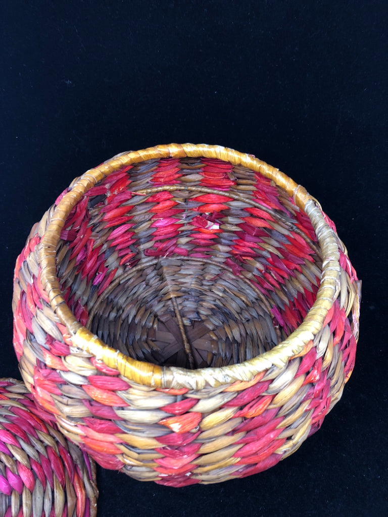 MULTI COLORED WOVEN COVERED BASKET.