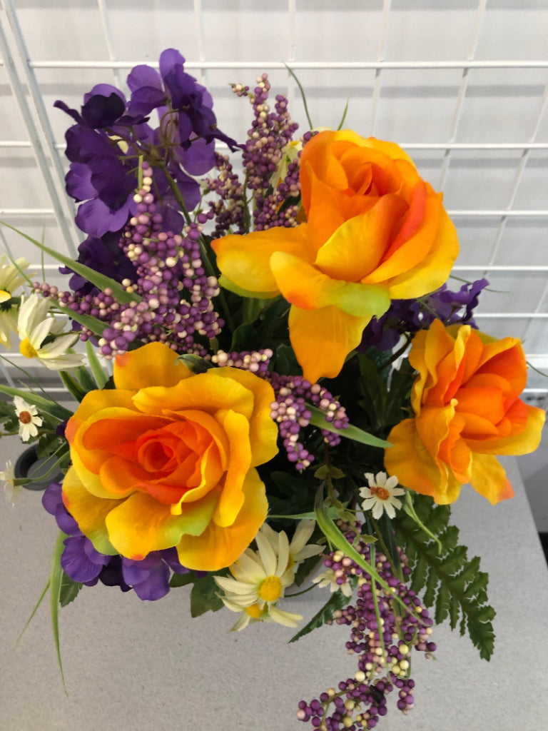 PURPLE/ORANGE FLOWERS IN BROWN VASE.
