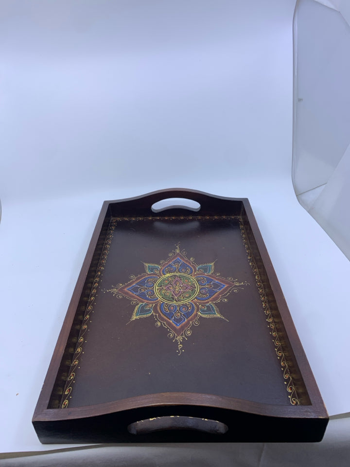 BROWN WOOD TRAY W/ COLORED MEDALLION IN CENTER W/ HANDLES.
