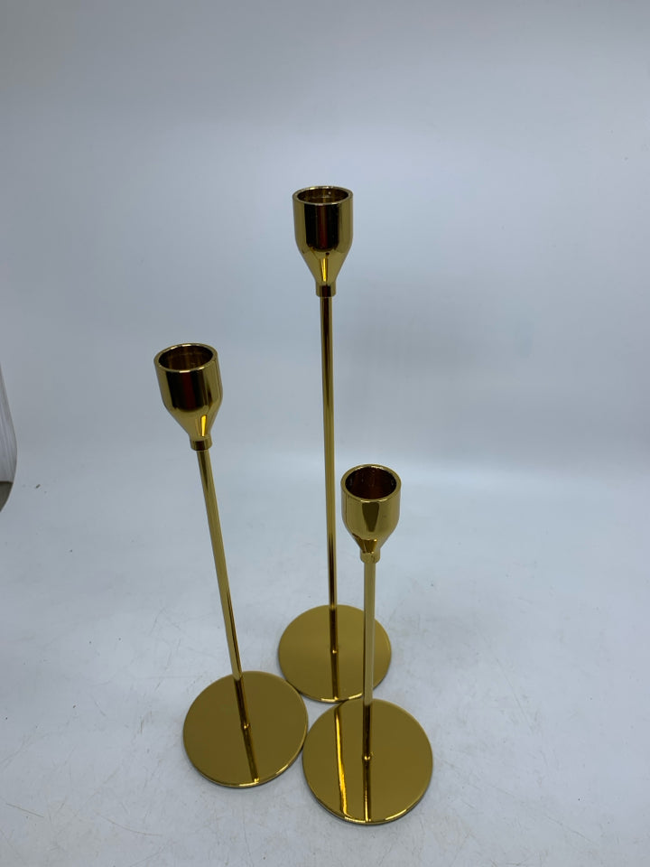3 GOLD SKINNY TAPERED CANDLE HOLDERS DIFFERENT SIZES.