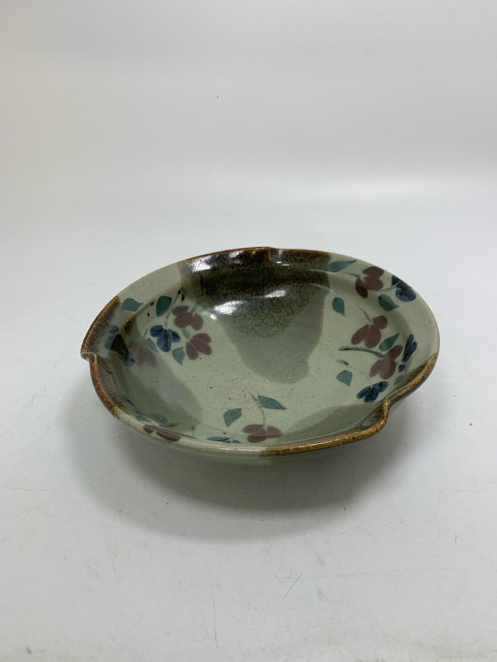 MULTI COLORED POTTERY BOWL W/ RED/BLUE FLOWERS UNEVEN EDGE.