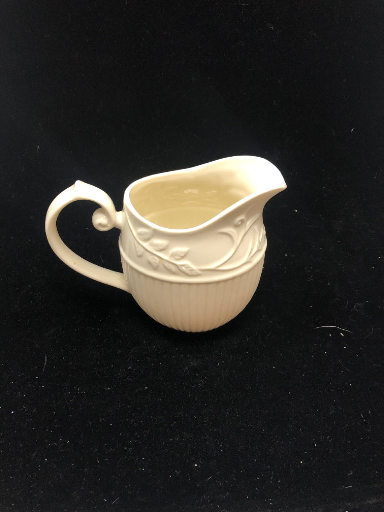 IVORY PITCHER EMBOSSED VINE LEAF PATTERN.