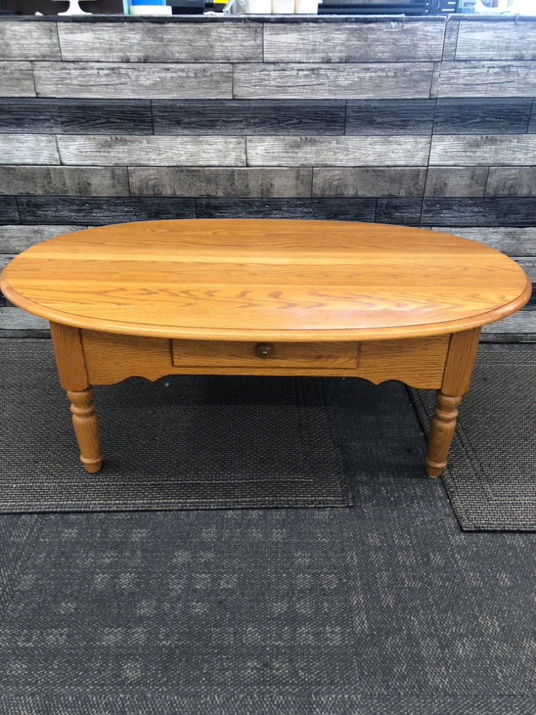 OVAL OAK WOOD COFFEE TABLE.
