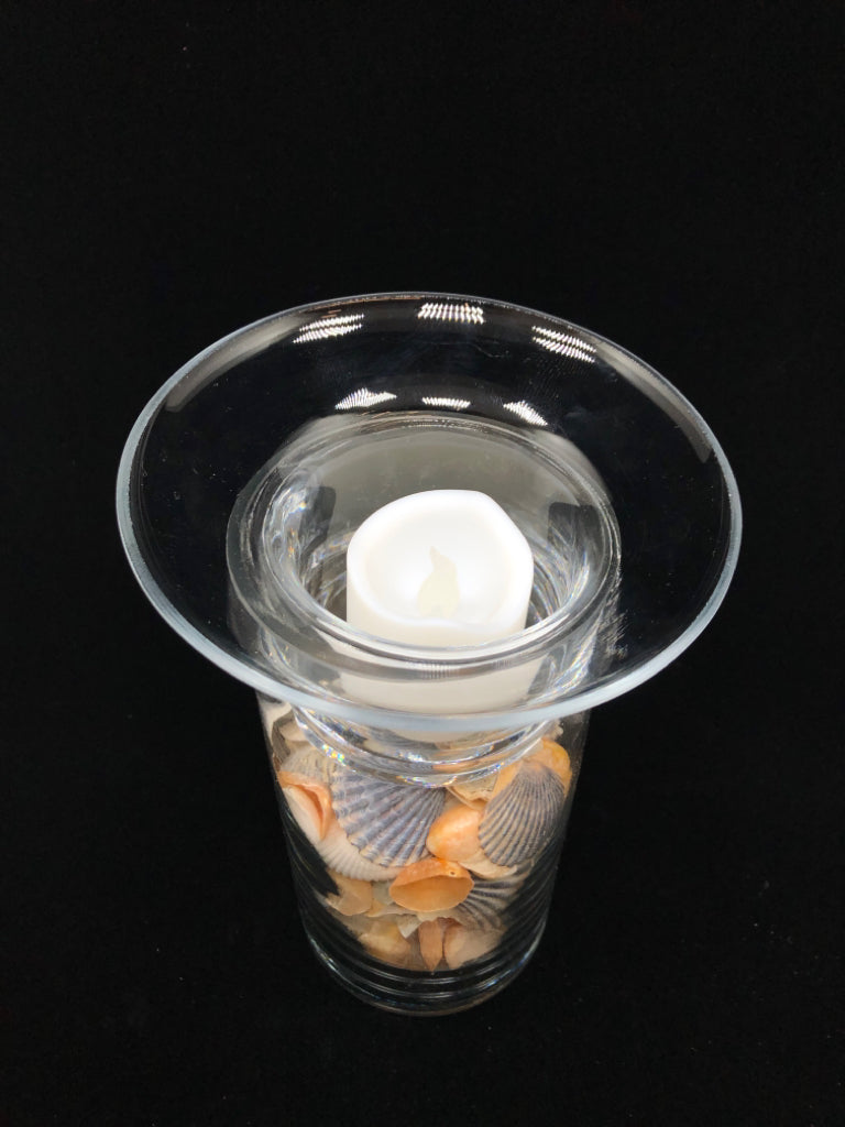 SEASHELL FILLED GLASS CANDLE HOLDER.