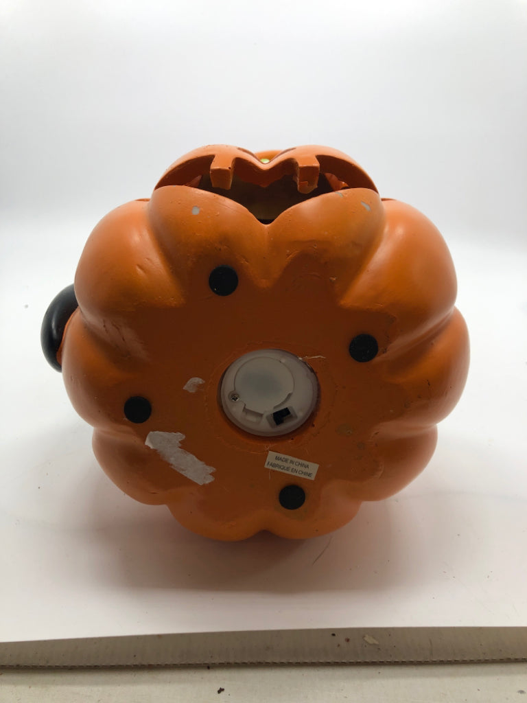BLACK CAT W/ CANDY HAT SITTING ON LIGHT UP JACKO LANTERN.