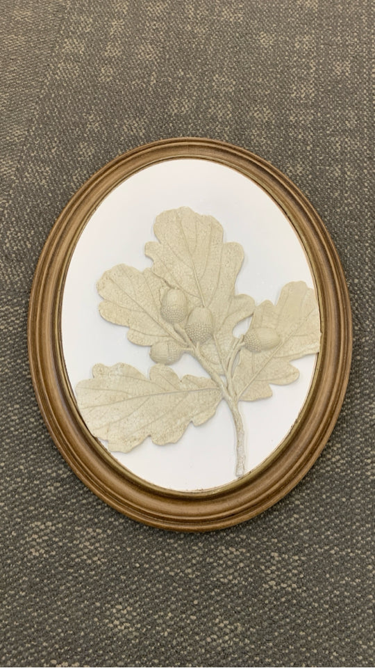 ACORNS AND LEAVES EMBOSSED ON ROUND WOOD FRAME.