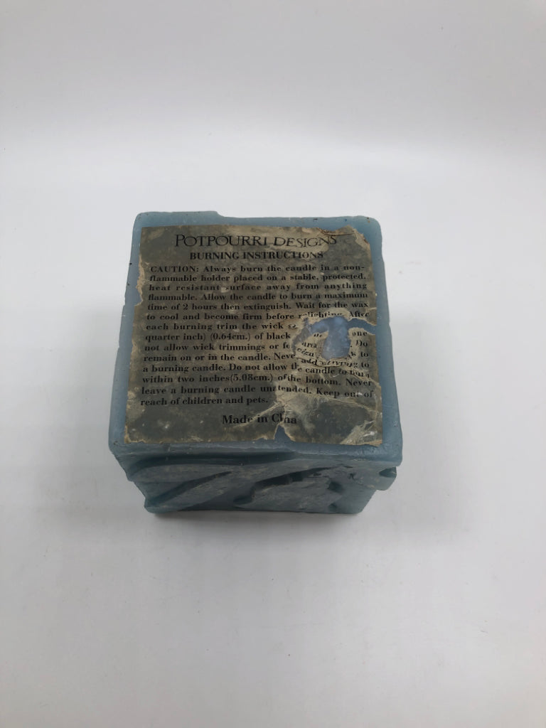 POTPOURRI DESIGNS SQUARE BLUE CANDLE W/FLORAL ETCHINGS.