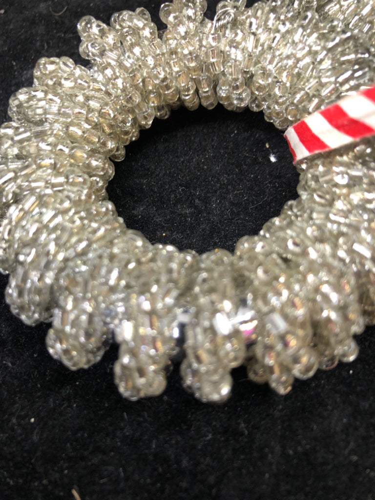 4 SILVER NAPKIN RINGS.