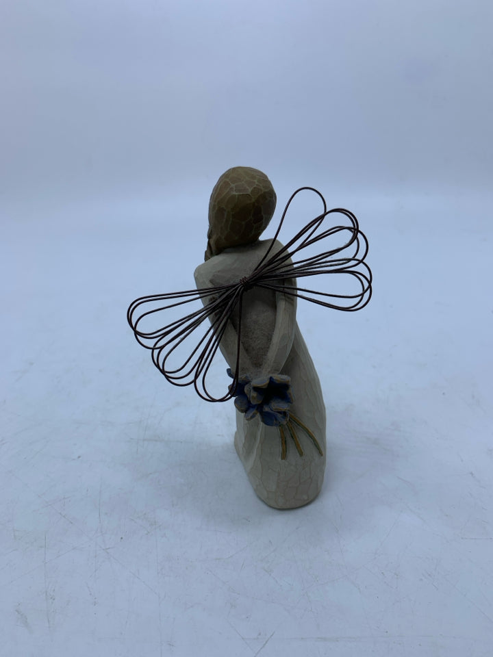 THANK YOU ANGEL HOLDING BLUE FLOWERS BEHIND HER.