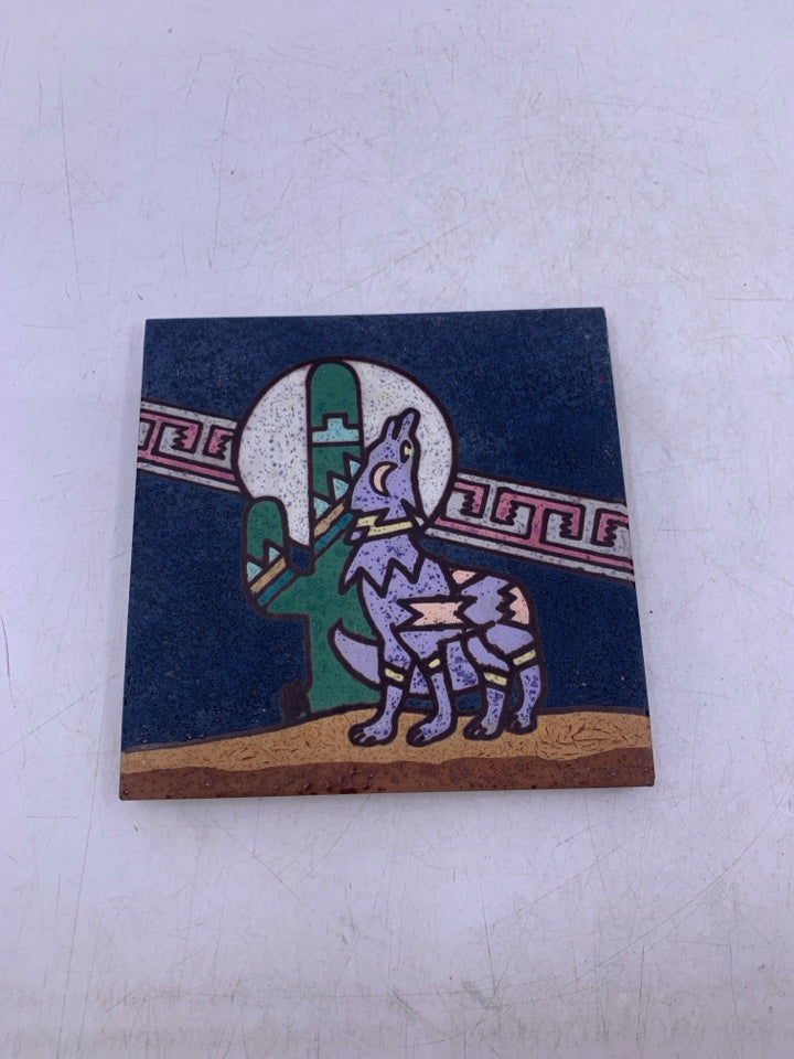 TERRA COTTA WOLF HOWLING AT THE MOON NEXT TO CACTUS.