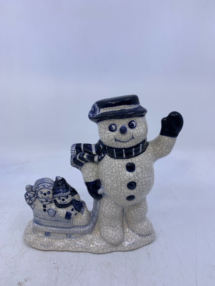 SNOWMAN PULLING HIS KIDS IN SLED WAVING.