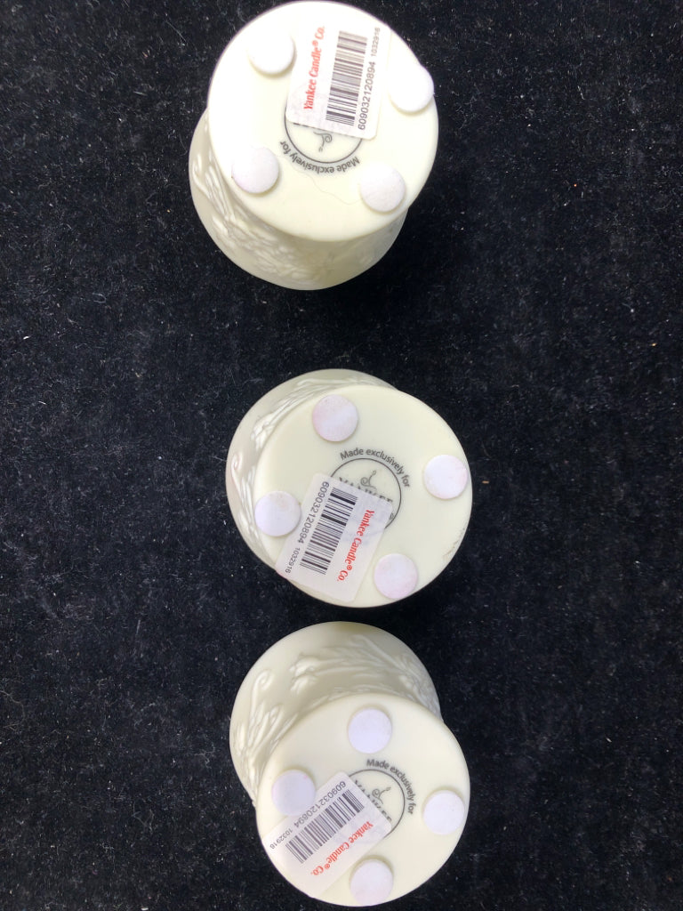 3 CREAM EMBOSSED YANKEE CANDLE TEALIGHT HOLDERS.