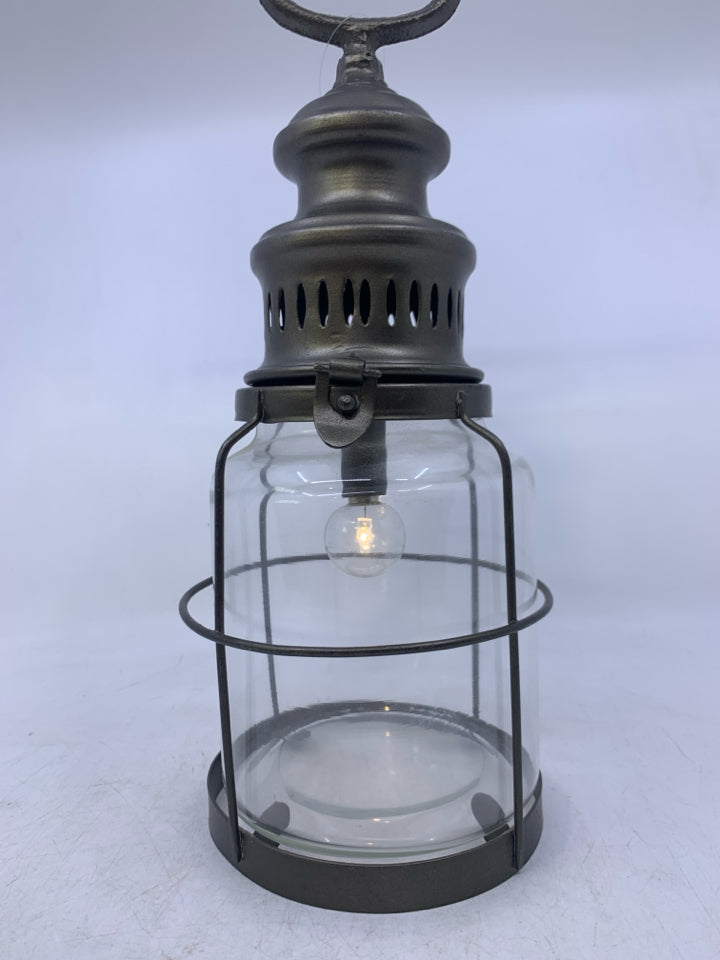 GREY METAL W/ GLASS BATTERY POWERED LANTERN.