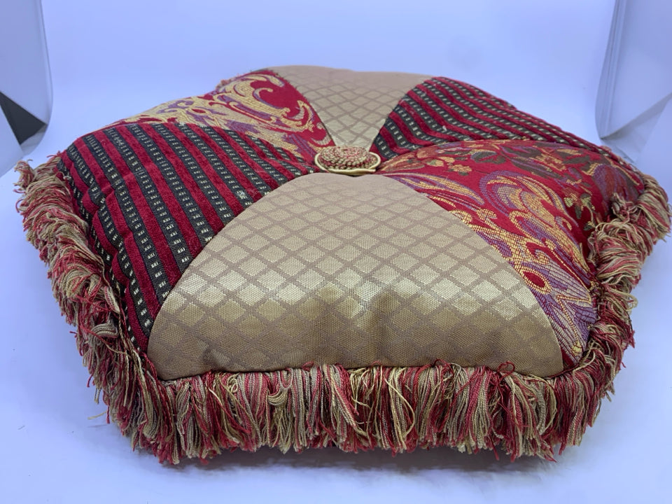 GOLD/RED HEXAGON PILLOW WITH FRINGE.