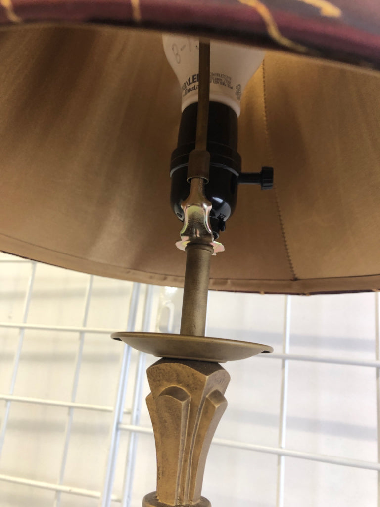 GOLD SKINNY BASE LAMP W MAROON AND GOLD ACCENTS SHADE.