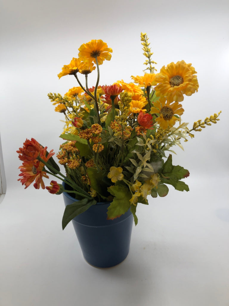YELLOW FAUX FLOWERS IN BLUE PLANTER.