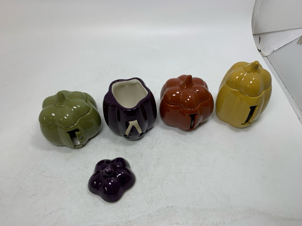 4 SMALL PUMPKIN TEA LIGHT HOLDERS SPELL OUT FALL.